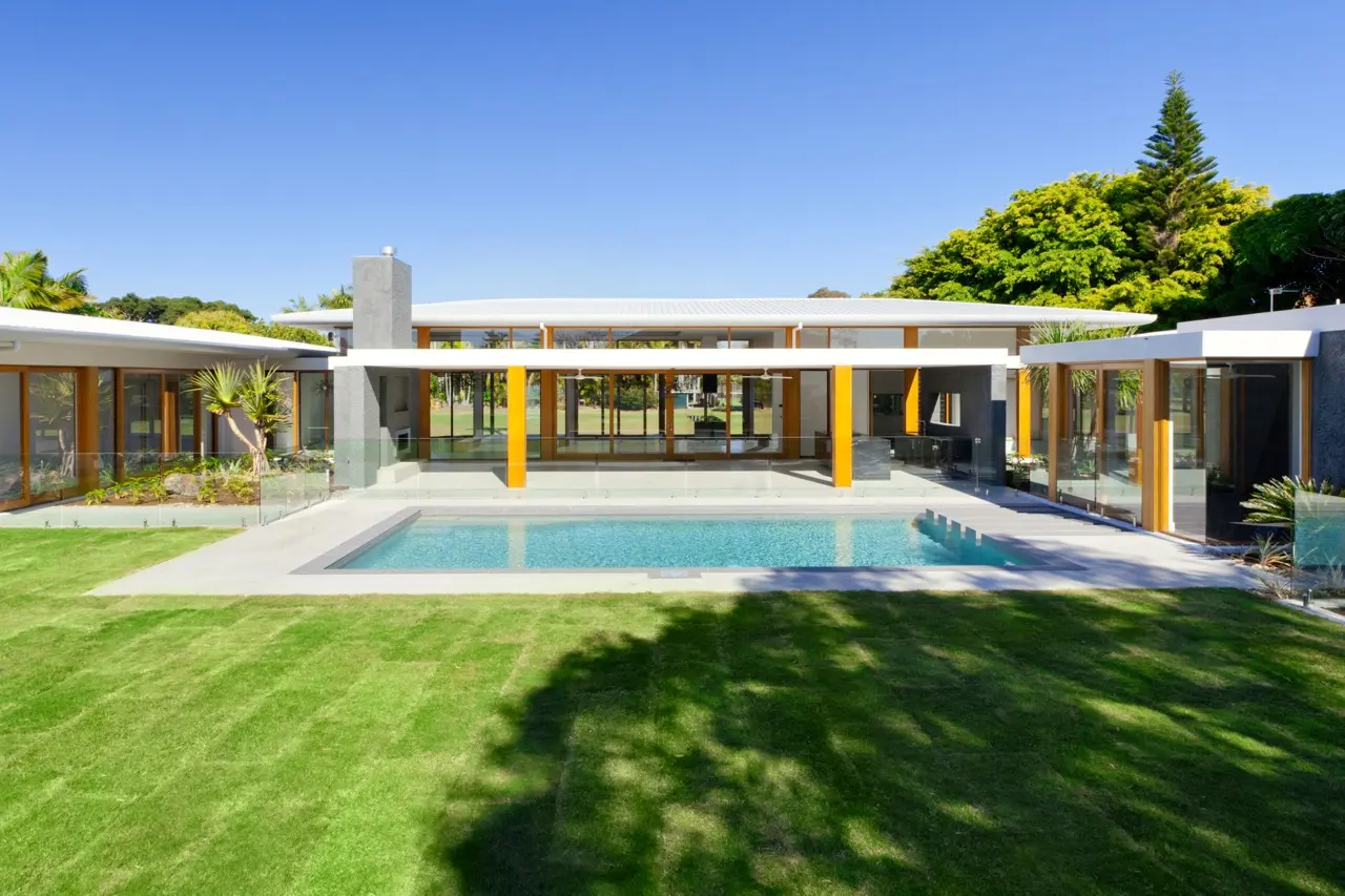Sunny exterior view of Modern home with swimming pool